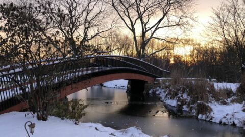 Snow covered bridge as the sun rises